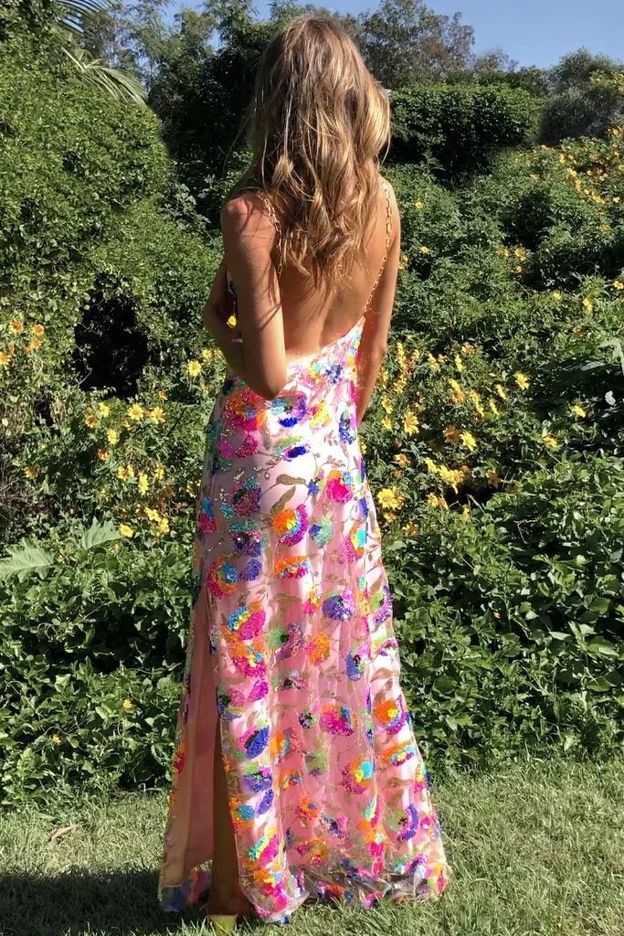 Robe longue fleurie en tissu léger, avec fente sur la jambe, col drapé et bretelles fines pour un look élégant.