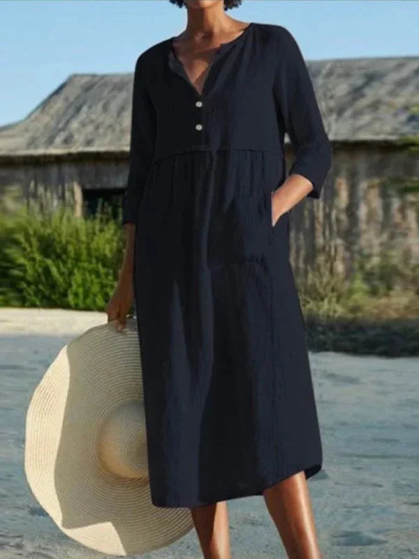 Robe midi femme noire en tissu léger, col en V, poches pratiques et manches 3/4 pour un style décontracté.