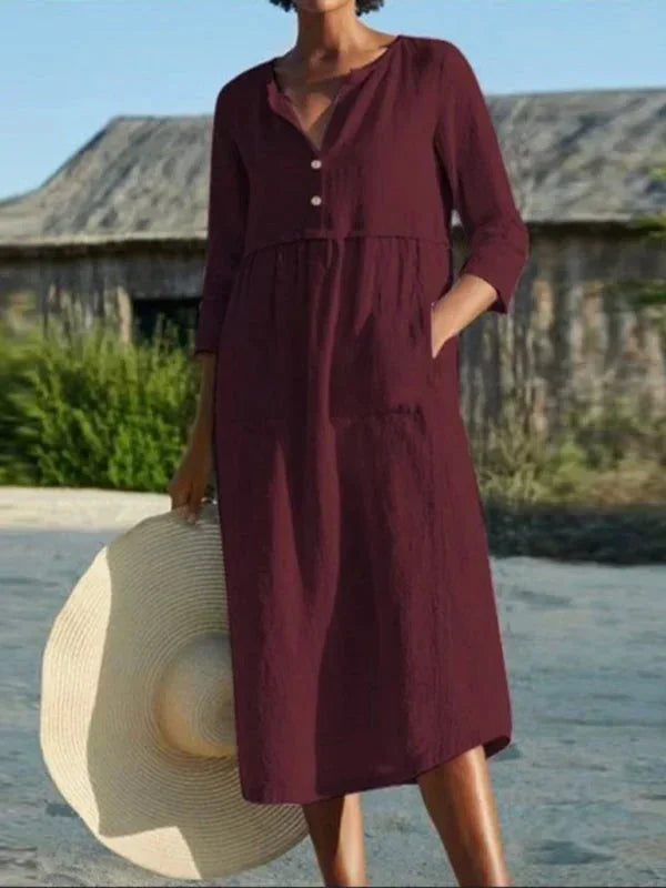 Robe midi rouge pour femme, col en V, manches 3/4, poches pratiques, en tissu léger et confortable pour un look décontracté.