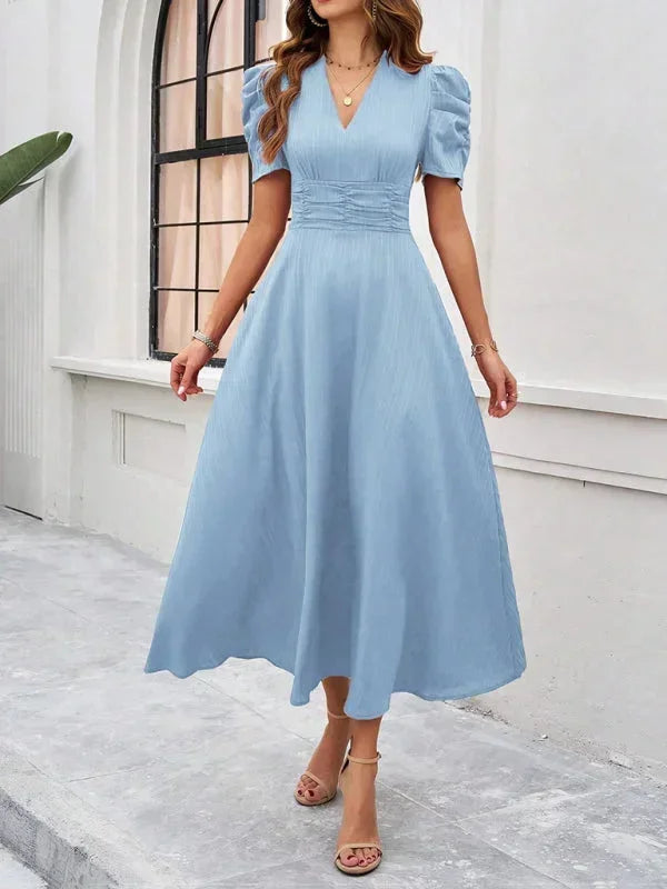Robe midi femme col V en coton léger avec manches bouffantes et imprimé floral, idéale pour les journées ensoleillées.