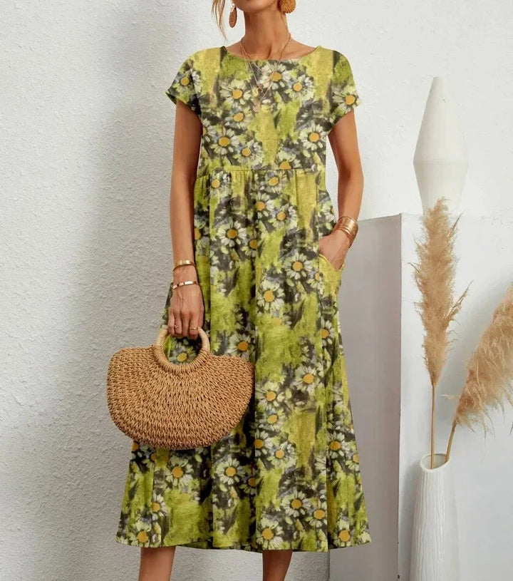 Robe midi en coton vert clair avec imprimé floral et poches, idéale pour une tenue décontractée et estivale.