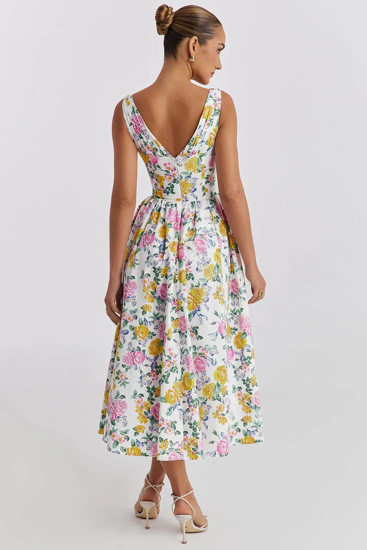Robe midi sans manches en coton, à motifs floraux colorés, idéale pour un look d'été léger et aéré.
