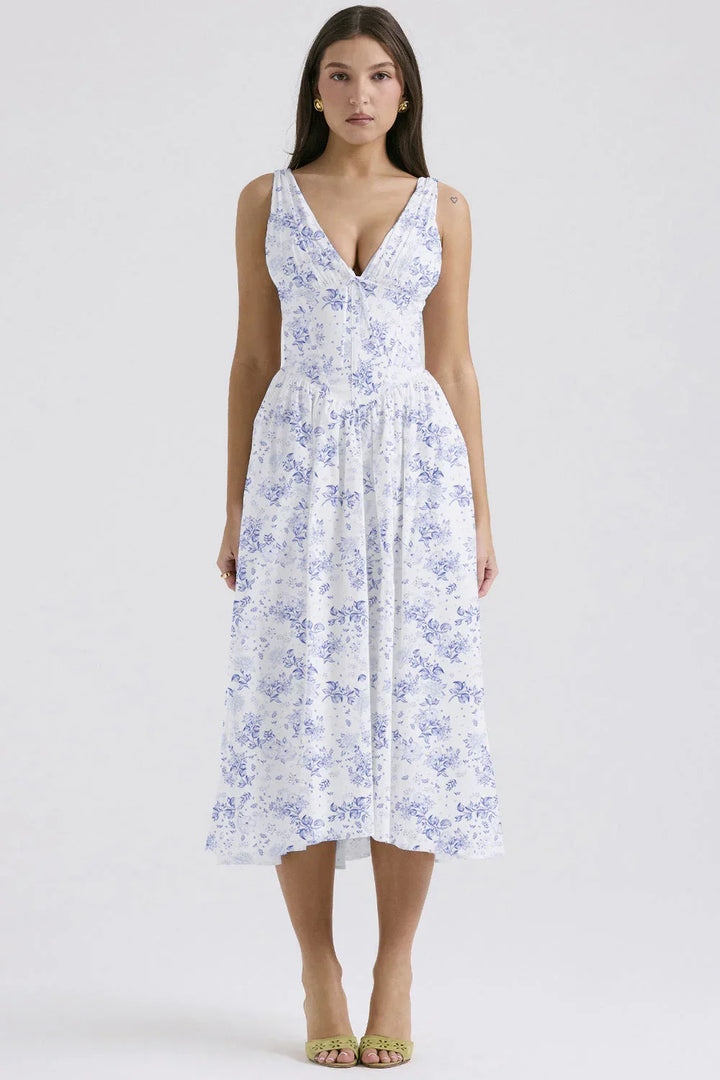 Robe midi sans manches bleu avec motif fleuri, en tissu léger et fluide, idéale pour les journées ensoleillées.