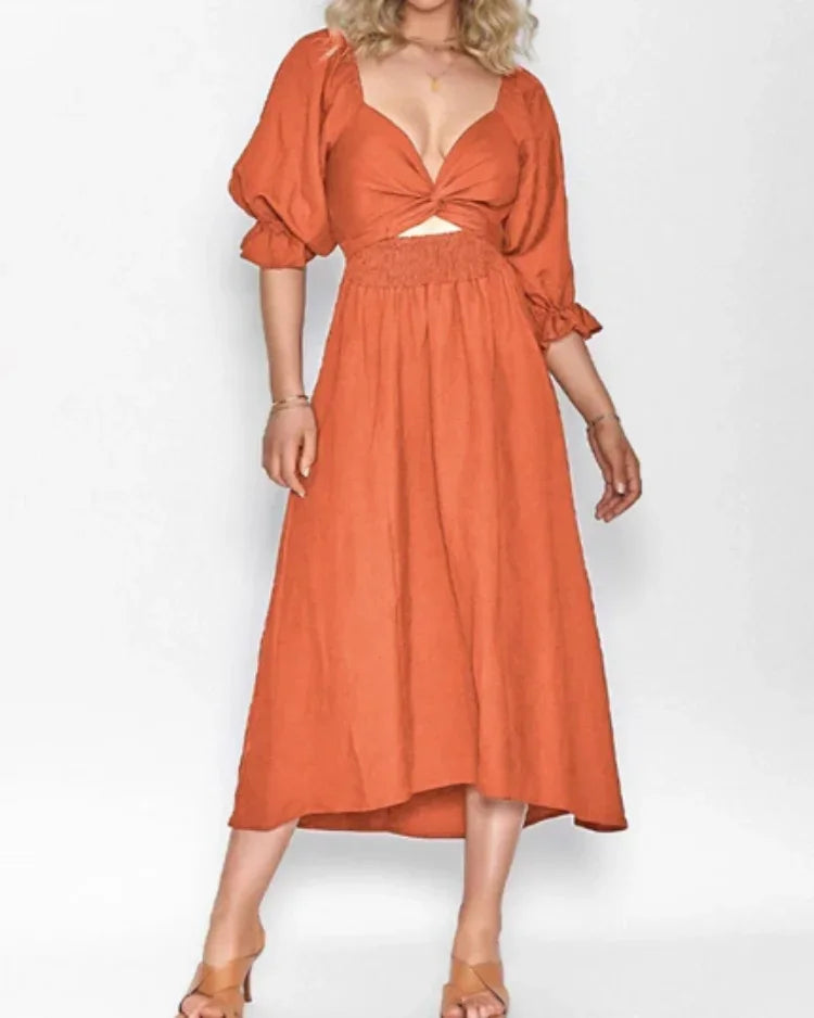 Robe midi portefeuille en tissu fluide, manches longues et col V, idéale pour un look décontracté et élégant.
