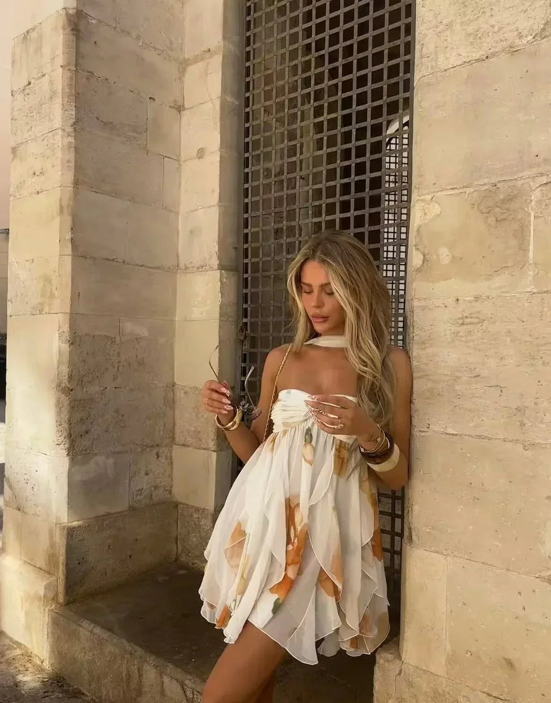 Robe mini blanche à imprimé floral orange, en coton léger, avec manches courtes et coupe évasée parfaite pour l'été.