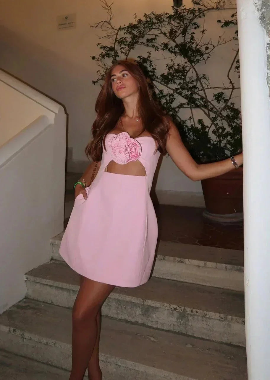 Robe courte florale à bustier découpé, en tissu léger, idéale pour les soirées d'été avec son motif de fleurs colorées.