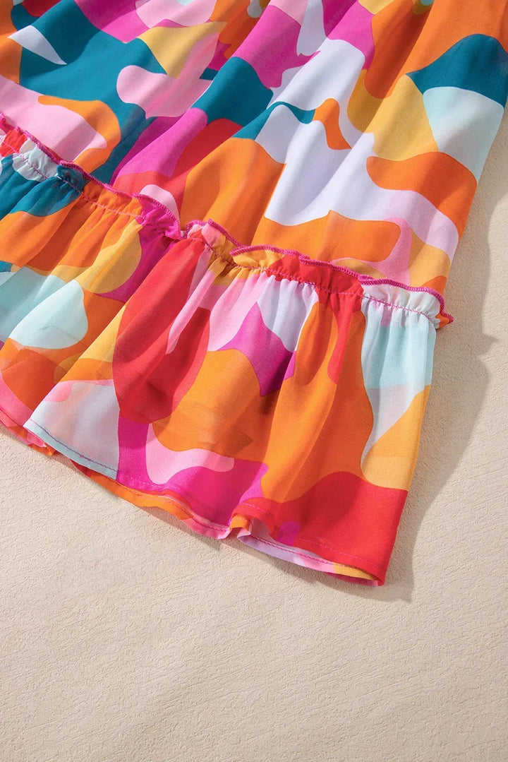 Robe courte à imprimé coloré, décolleté en V, manches longues, en coton léger, idéale pour les journées d'été à la plage.