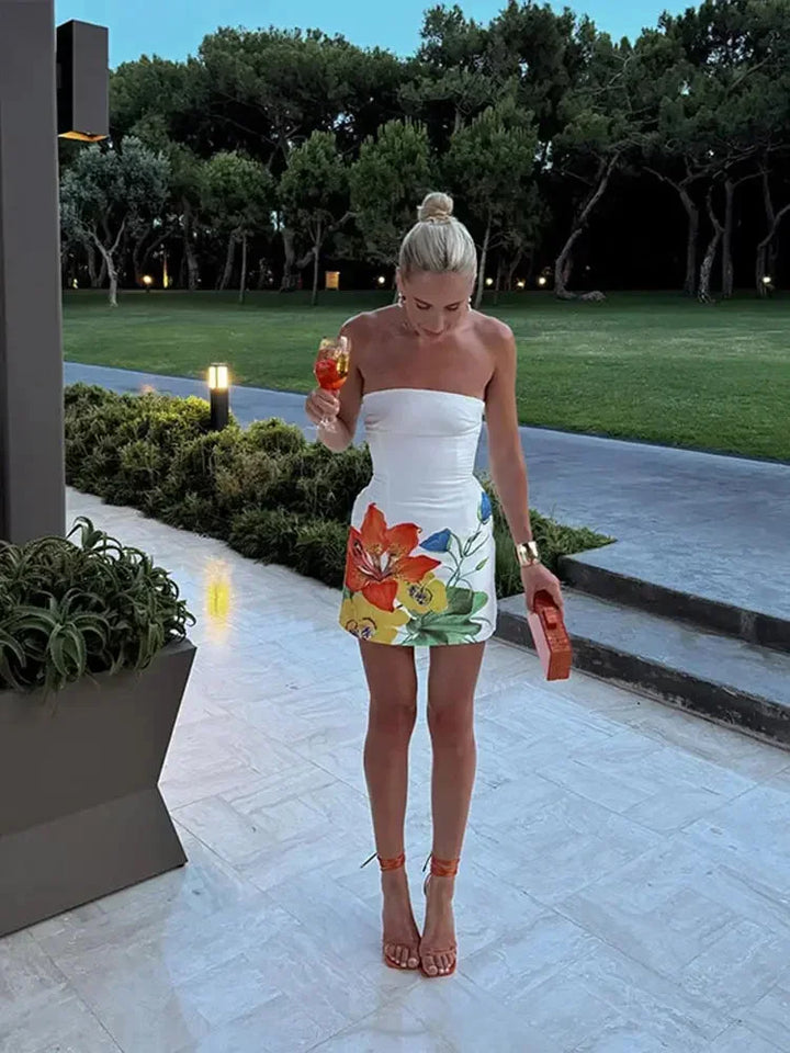 Robe courte sans bretelles, tissu léger, motifs floraux vibrants pour soirées d'été, style décontracté et féminin.