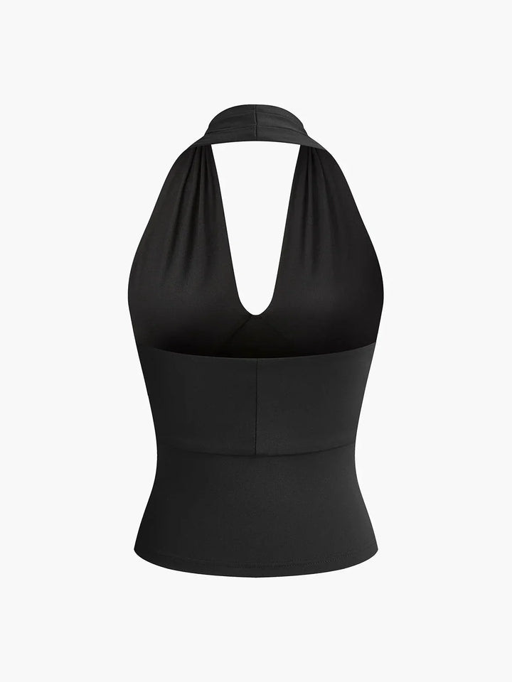 Top femme en tissu léger, dos-nu avec croisement avant, conçu pour un look élégant et décontracté. Idéal pour les journées…