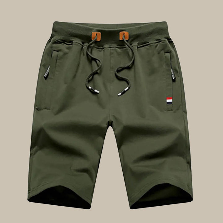 Pantaloncini cargo verde oliva da uomo con coulisse, tasche laterali con zip, dettagli tricolore. Ideali per attività all'aperto e casual.